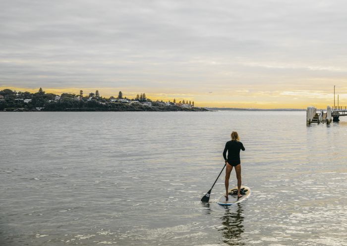 Stand Up Paddleboarding, Bundeena Man enjoying a morning of stand up paddleboarding in Port Hacking near Bundeena Wharf, Bundeena