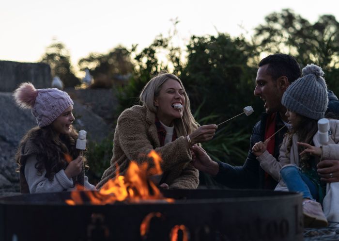 Family toasting marshmallows on Sydney Harbour
