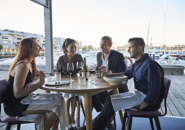 Friends enjoying food and drink at waterside restaurant LuMi Bar & Dining in Pyrmont