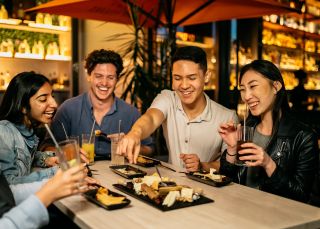 Friends enjoying food and drinks at Nick and Noras, Parramatta