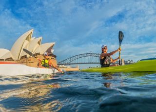 Kayakers enjoying Sydney harbour near the Sydney Opera House with the Sydney harbour bridge in the background, Sydney Harbour