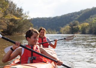 Mother and son enjoying a day of kayaking along Hawkesbury River, near Lower MacDonald