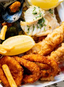 Couple enjoying fish and chips at Balmoral Beach, Mosman