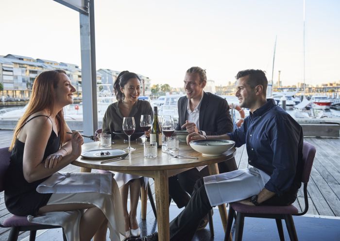 Friends enjoying food and drink at waterside restaurant LuMi Bar & Dining in Pyrmont