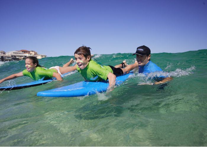 Children learning to surf with 'Let's Go Surfing' at Bondi