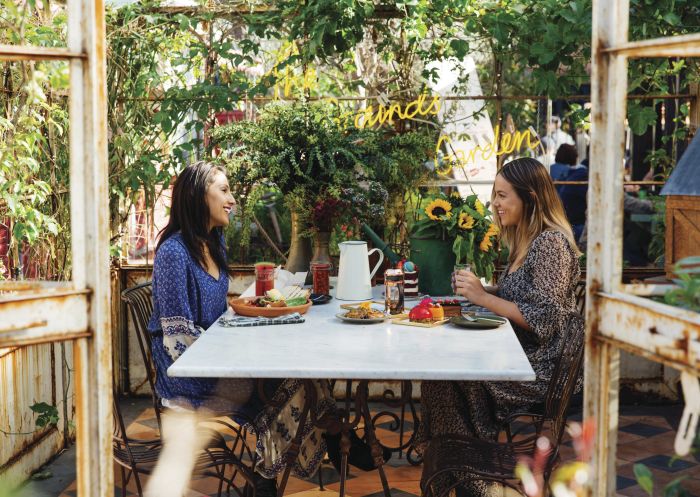 Friends enjoying breakfast and morning tea at the Grounds of Alexandria in Alexandria, Sydney