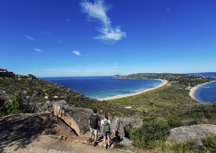 Couple enjoying a scenic coastal hike on the Barrenjoey Lighthouse Walk in Palm Beach, Sydney