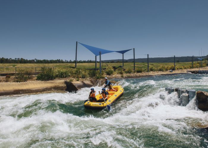 Couple enjoying a white water rafting experience at Penrith Whitewater Stadium in Sydney's west.