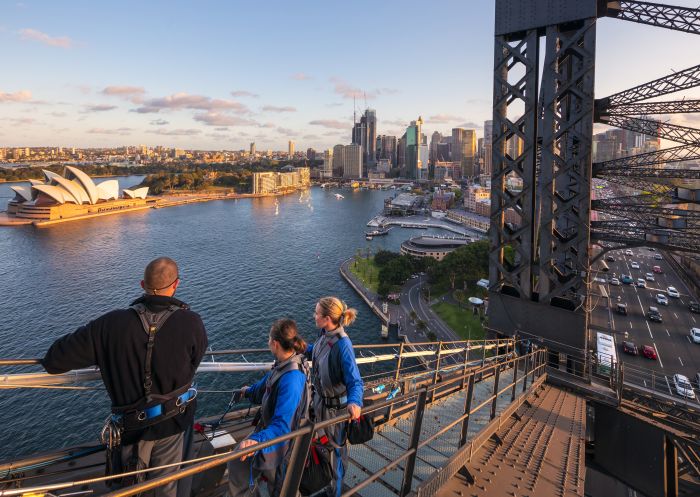 Friends enjoying a twilight BridgeClimb Sydney experience overlooking Sydney Harbour