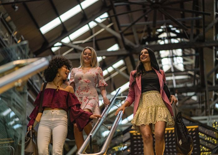 Friends walking through the lobby at Ovolo Hotel, Woolloomooloo