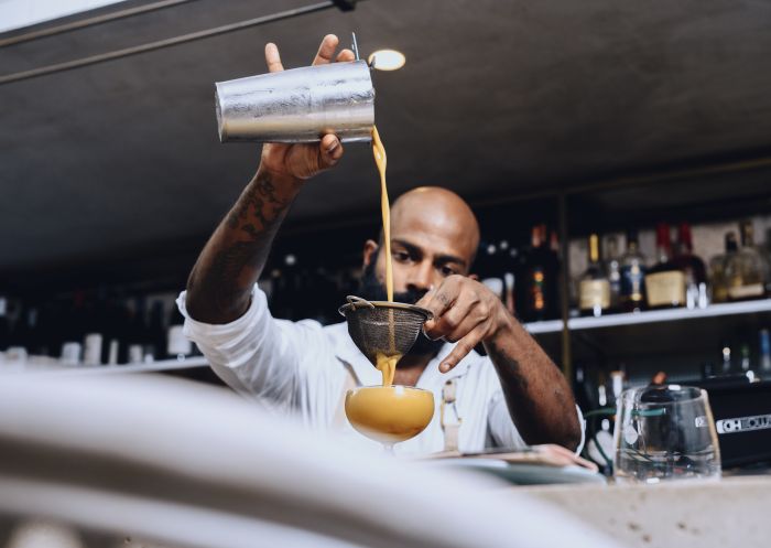 Bartender creating a cocktail at The Butler bar located on Victoria Street, Potts Point