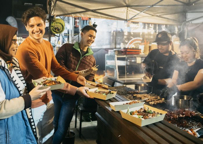 Friends enjoying bbq grill at Smoky Cravings, Lakemba