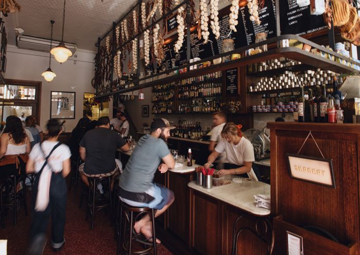 People enjoying food and drink at Continental Deli Bar Bistro in Newtown, Inner Sydney