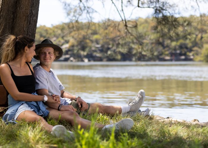Couple enjoying the views across the scenic Georges River in Georges River Nature Reserve, Campbelltown