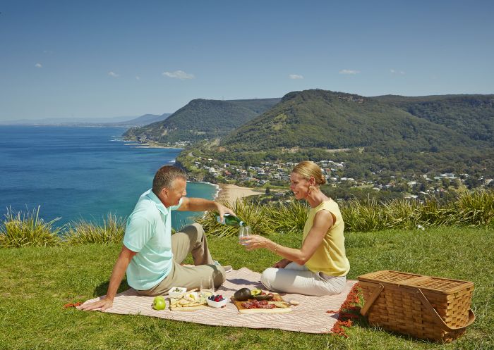 Couple enjoying a picnic with scenic views at Stanwell Tops Lookout, Royal National Park