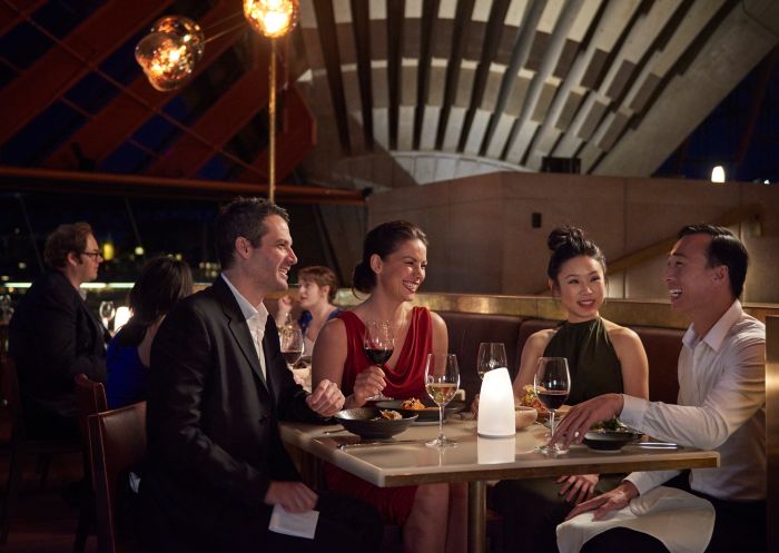 Couples enjoying an evening out at Bennelong Restaurant, Sydney