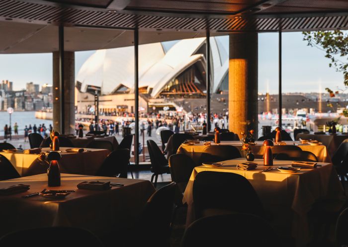 Interiors of the fine dining Aria Restaurant with exterior views of the Sydney Opera House, Circular Quay