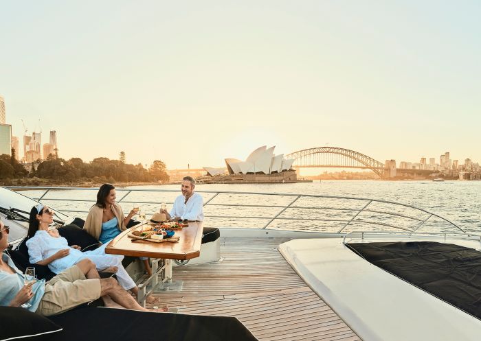 Friends enjoying drinks and snacks on board the Ghost 2 Super Yacht, Sydney Harbour