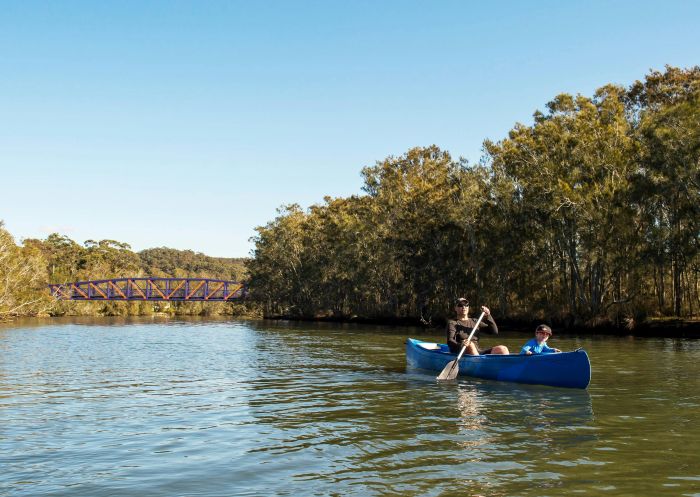 Man and his son in a canoe on Narrabeen Lagoon, Narrabeen