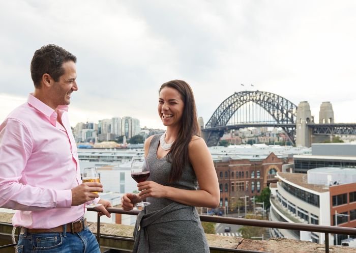 Couple enjoying a drink on the rooftop at Henry Deane at Hotel Palisade, Millers Point