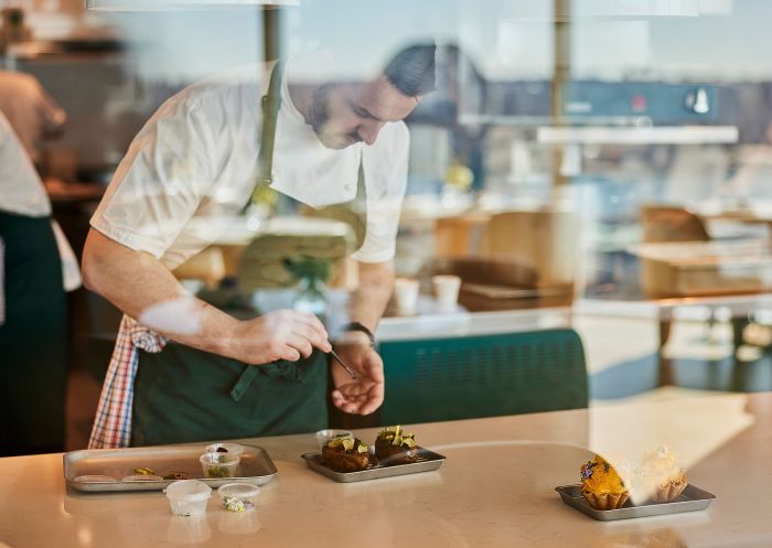 Chef adding finishing touches to a dish at Oncore by Clare Smyth at Crown Towers, Barangaroo