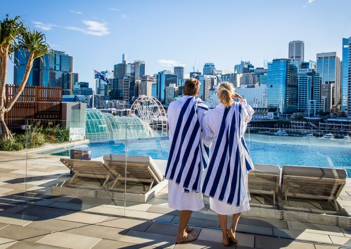 Couple enjoying the view from the pool at Sofitel Sydney, Darling Harbour