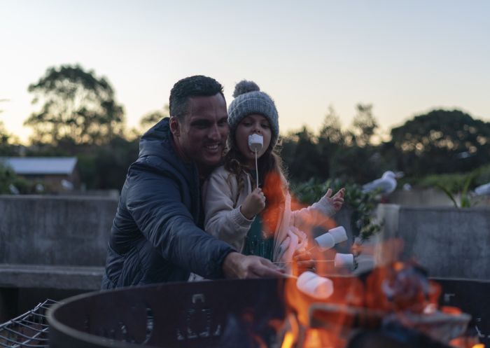 A father and child enjoying near fire at Cockatoo Island in Sydney Harbour