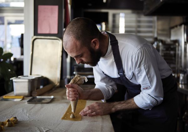 Chef preparing pasta at LuMi Dining, on a Pyrmont wharf