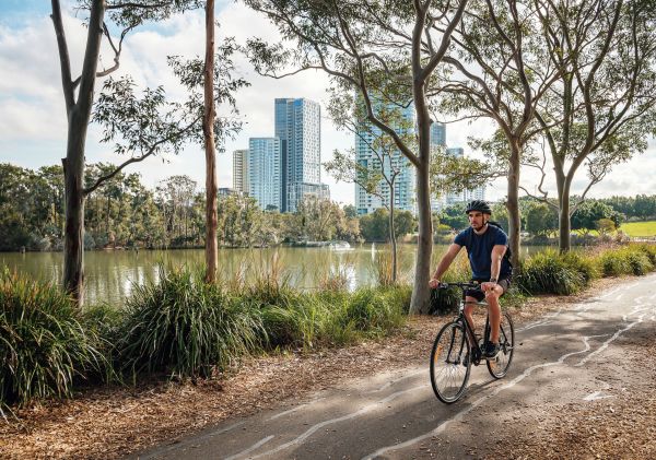 A cyclist riding on the bike trail in Bicentennial Park, Sydney Olympic Park