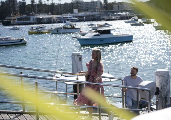 Couple arriving by boat to Manly 16ft Skiff Sailing Club, Manly