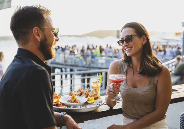 Couple enjoying food and drink at Manly Wharf Hotel, Manly