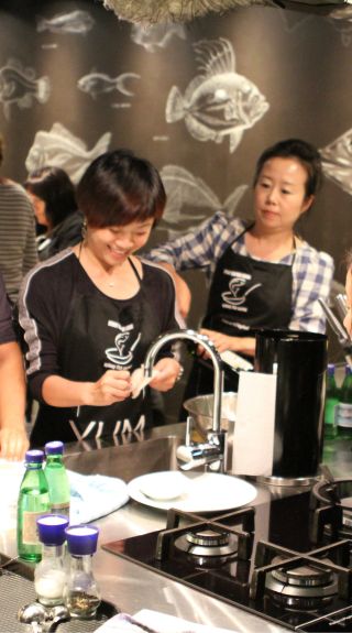 Small group enjoying a cooking class at the Sydney Seafood school, Sydney Fish Market