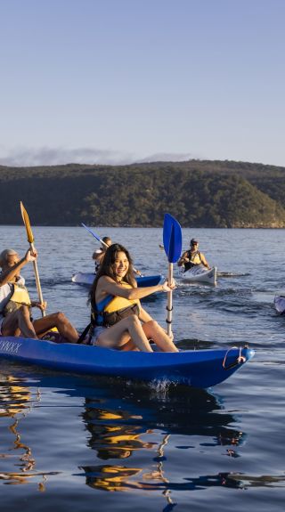 Friends enjoying a sunrise kayaking experience in Pittwater with Pittwater Kayak Tours, Palm Beach