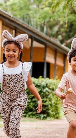 Two children playing egg and spoon race at Elizabeth Farm, Parramatta