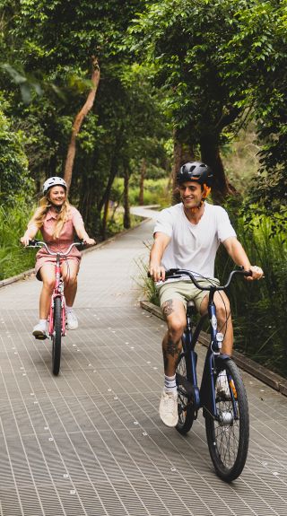 Couple enjoying ride on the Narrabeen Lagoon Trail, Narrabeen