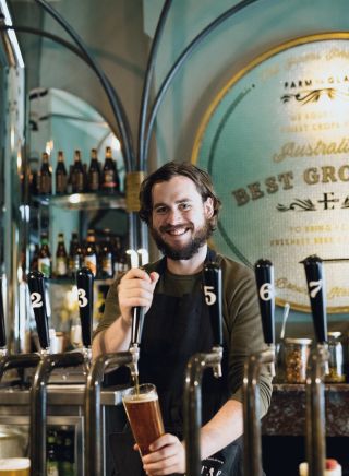 Bartender pouring a beer at the Endeavour Tap Rooms, The Rocks