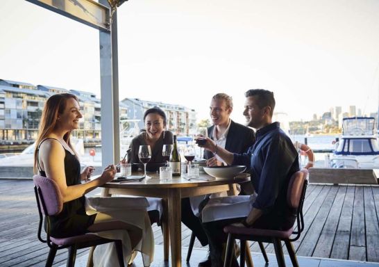 Friends enjoying food and drink at waterside restaurant LuMi Bar & Dining, Pyrmont