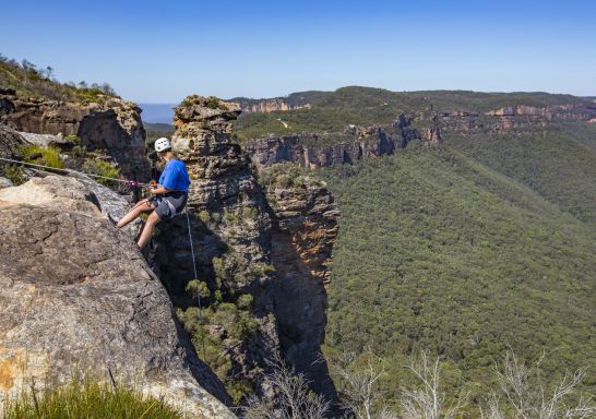 Woman abseiling at Cahills Lookout, Katoomba in the Blue Mountains