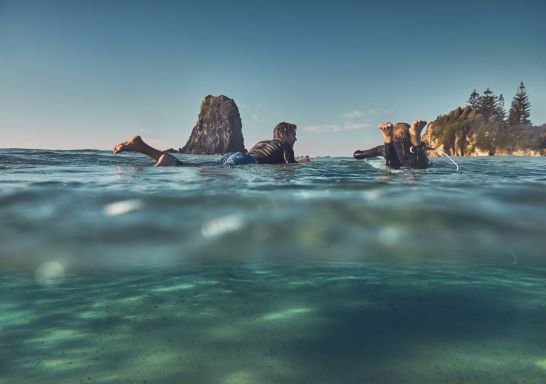 Father and son enjoying a morning surf at Glasshouse Rocks in Narooma, South Coast